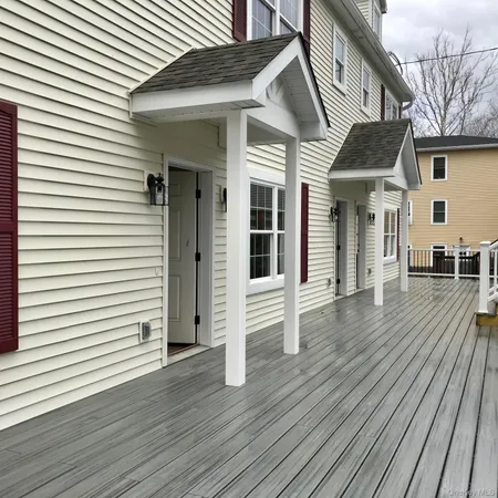 a view of a white house with wooden floor