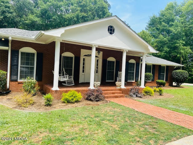 72 Bolingview Road Juliette, GA 31046 - Photo 2 of 4 a view of a house with a yard chairs and table in a patio