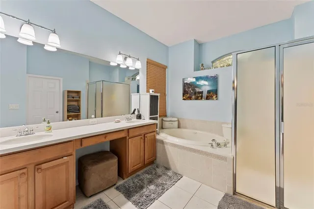 a bathroom with a tub sink and mirror
