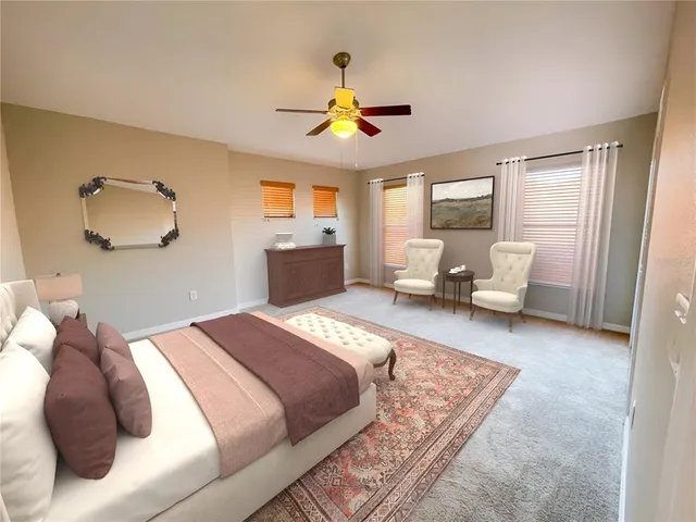 a bedroom with a bed couch and window