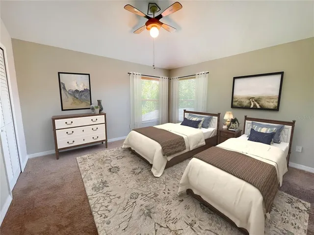 a bedroom with two beds and painting on the wall