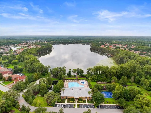 an aerial view of a house with a garden and lake view