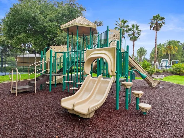 a view of a wooden chairs and a table in the patio