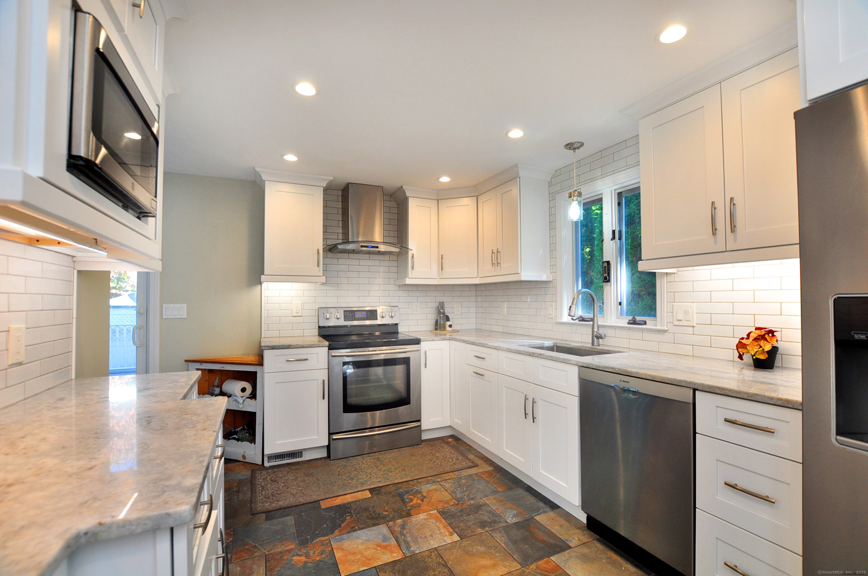 274 Smith Street South Windsor, CT 06074 - Photo 11 of 38 a kitchen with stainless steel appliances granite countertop a stove a sink and a microwave