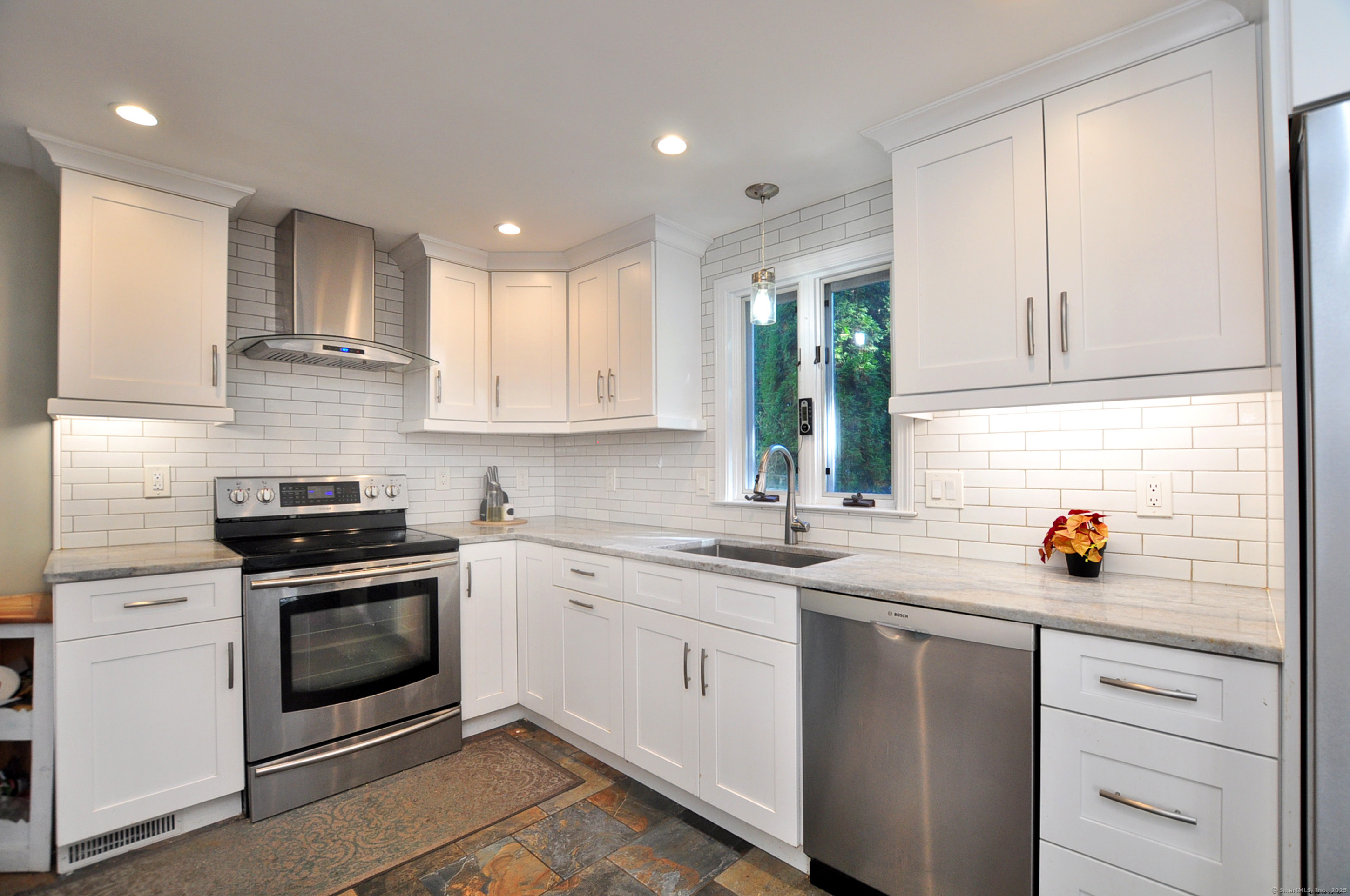 274 Smith Street South Windsor, CT 06074 - Photo 12 of 38 a kitchen with a stove sink and cabinets