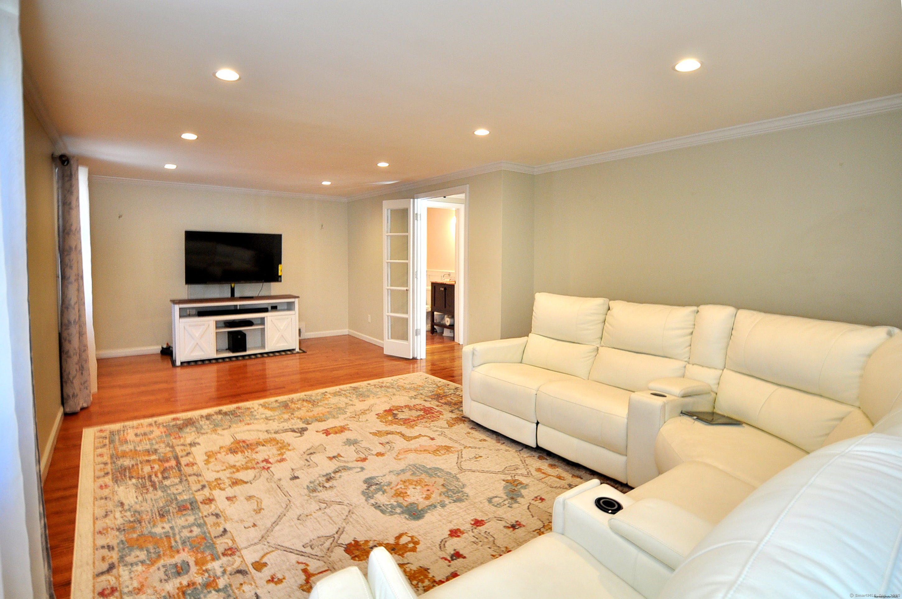 274 Smith Street South Windsor, CT 06074 - Photo 18 of 38 a living room with a flat screen tv and a couch