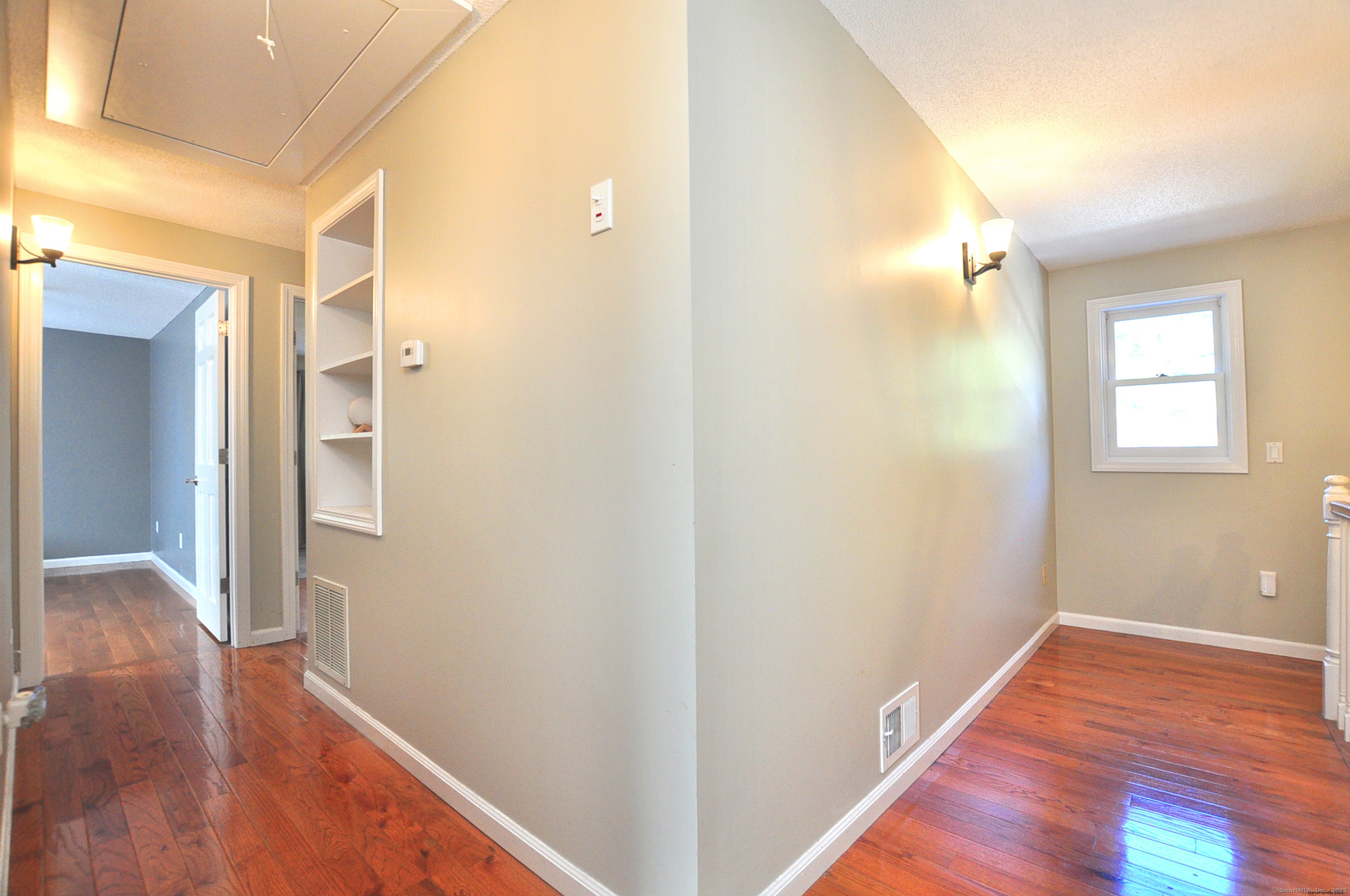 274 Smith Street South Windsor, CT 06074 - Photo 26 of 38 a view of hallway with hardwood floor and a window