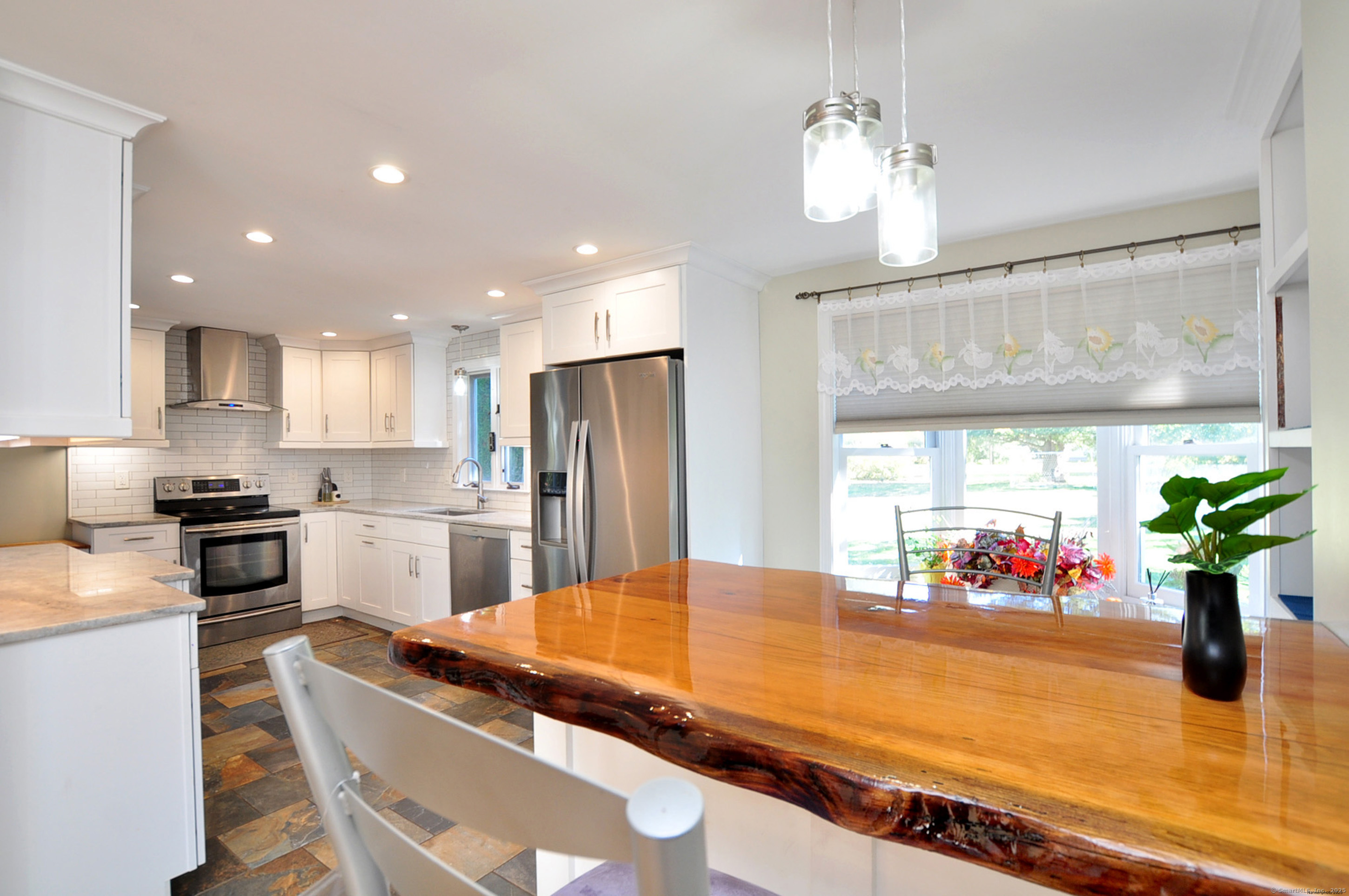 274 Smith Street South Windsor, CT 06074 - Photo 10 of 38 a room with kitchen island granite countertop stainless steel appliances lots of counter space and window