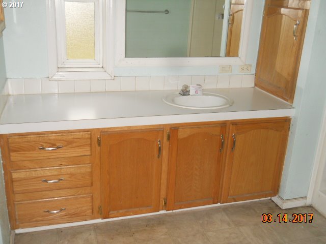 10045 South Prairie Road Tillamook, OR 97141 - Photo 17 of 24 a bathroom with a sink and a mirror