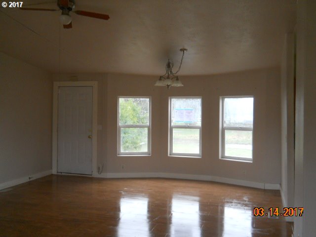 10045 South Prairie Road Tillamook, OR 97141 - Photo 9 of 24 a view of an empty room with wooden floor and a window