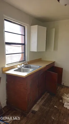 a bathroom with a sink shower and a mirror