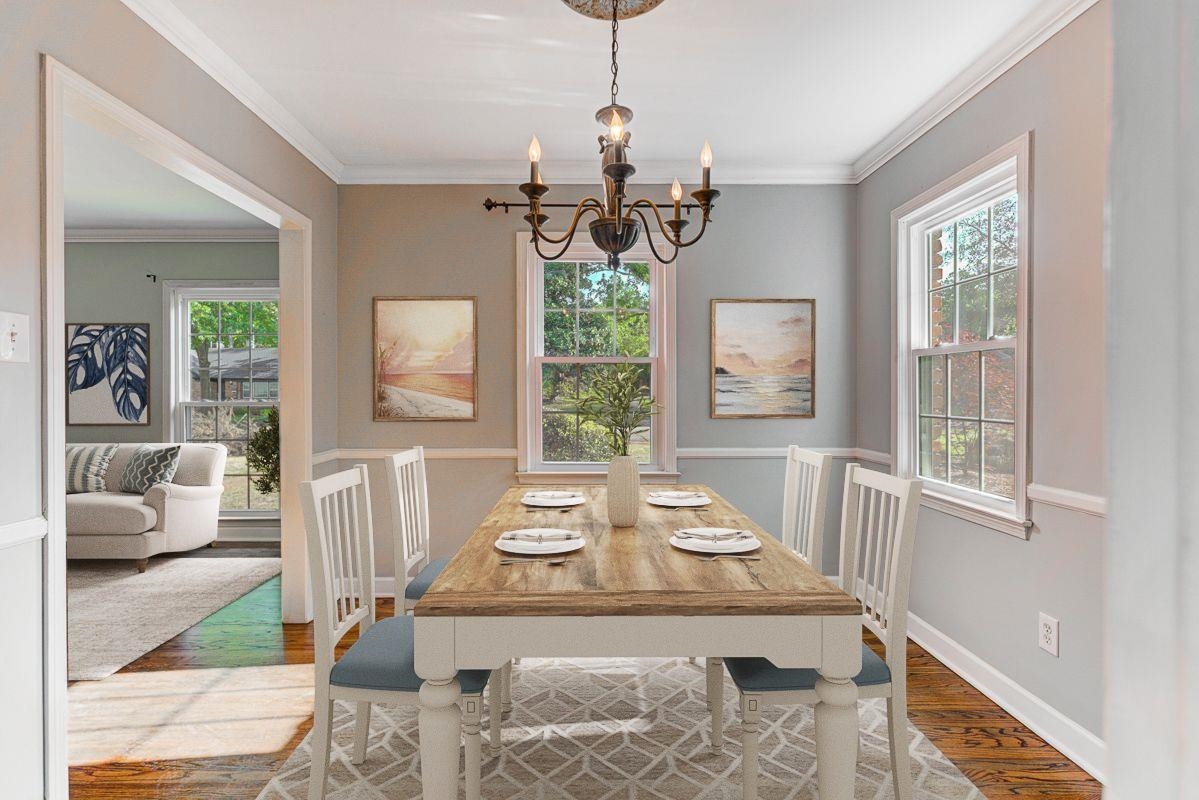 5676 Barfield Road Memphis, TN 38120 - Photo 5 of 23 Formal dining space featuring wood-finish flooring, white crown molding, and a classic chandelier