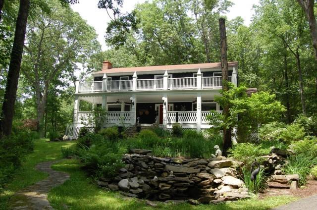 50 Birch Hill Road Newtown, CT 06470 - Photo 1 of 1 a front view of a house with a yard