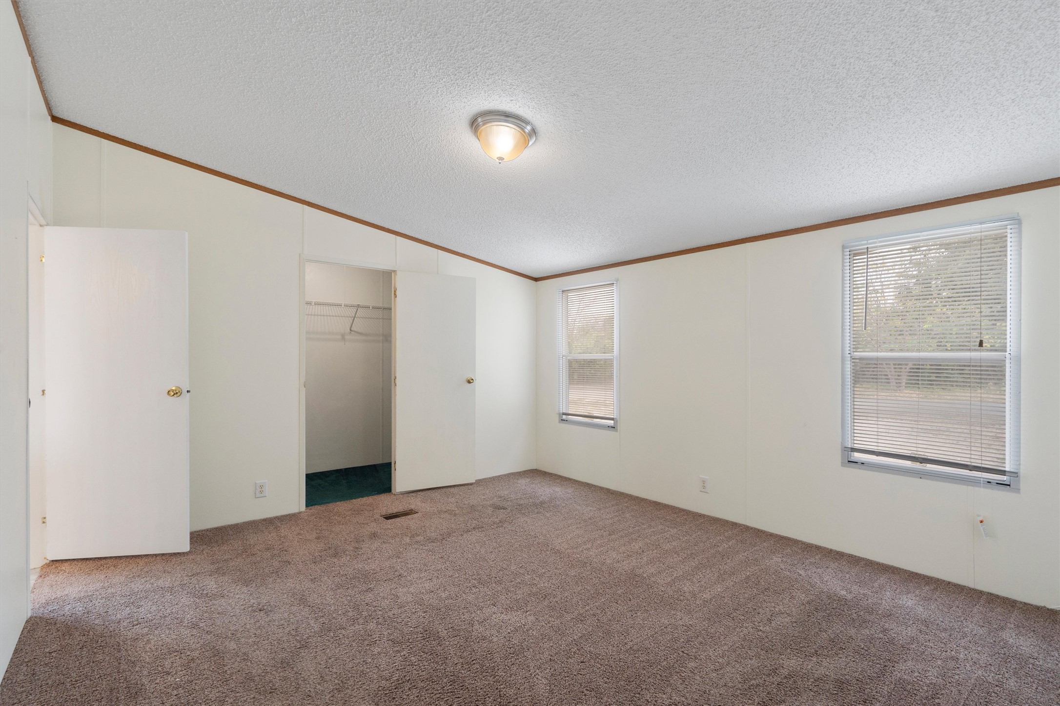 3075 Old Black Colony Road, Unit D Buda, TX 78610 - Photo 11 of 26 Vaulted ceilings and plush carpeting define this comfortable bedroom space.