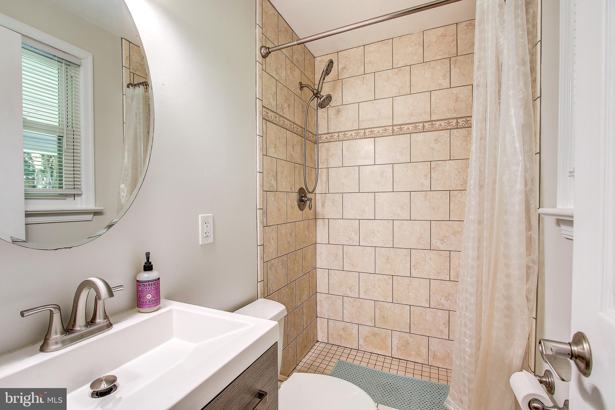 13846 Penn Shop Road Mount Airy, MD 21771 - Photo 16 of 42 a bathroom with a sink toilet and shower