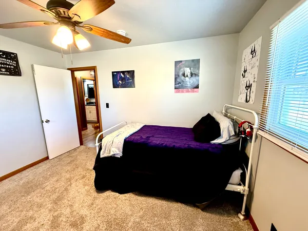 a bed sitting in a bedroom next to a window