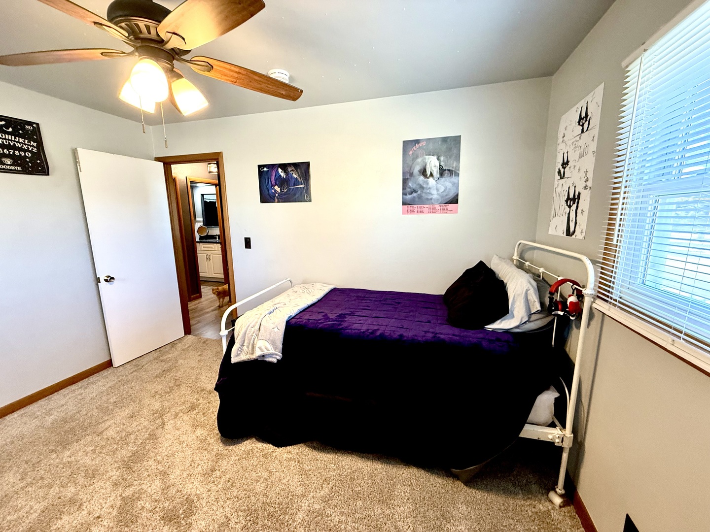 1703 24th Street Rock Island, IL 61201 - Photo 14 of 28 a bed sitting in a bedroom next to a window
