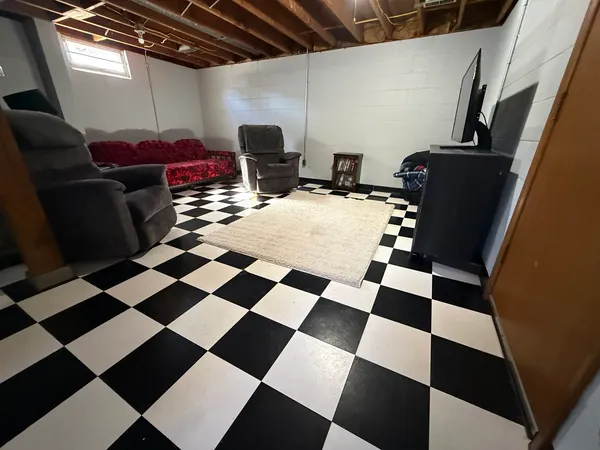 a bedroom with furniture and a window