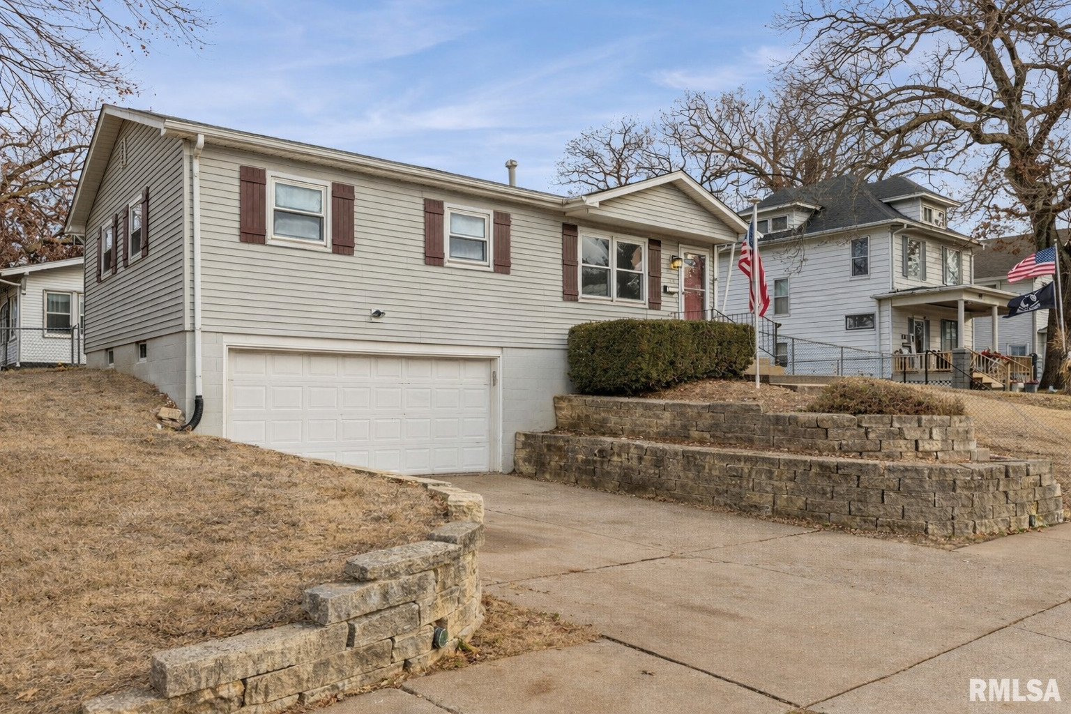 1703 24th Street Rock Island, IL 61201 - Photo 2 of 28 a front view of a house with a yard