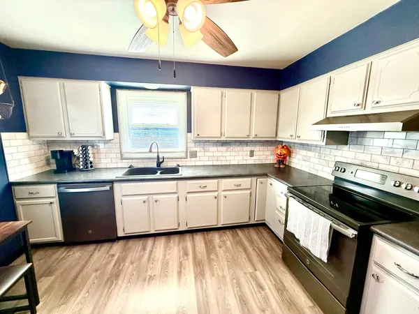 a kitchen with a sink stove and window
