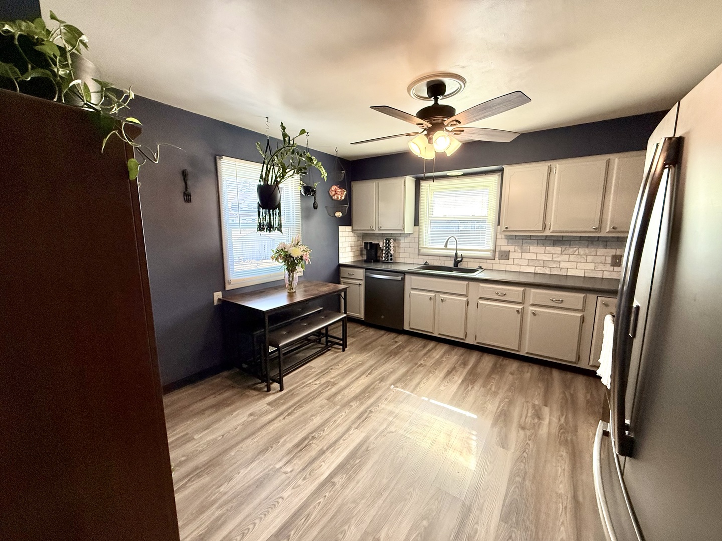 1703 24th Street Rock Island, IL 61201 - Photo 9 of 28 a kitchen with stainless steel appliances granite countertop a refrigerator a sink dishwasher a stove and white countertops with wooden floor