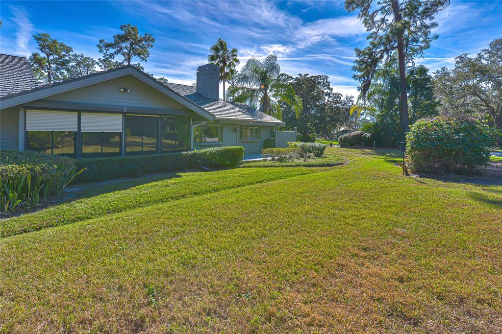 5355 Cobblestone Court Wesley Chapel, FL 33543 - Photo 12 of 54 a front view of a house with swimming pool having outdoor seating