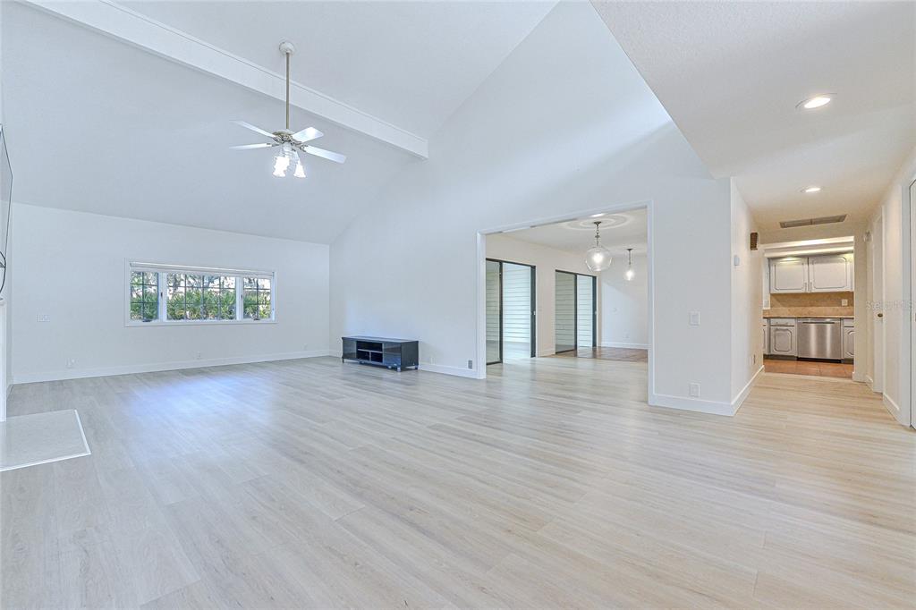 5355 Cobblestone Court Wesley Chapel, FL 33543 - Photo 16 of 54 an empty room with wooden floor cabinet and windows