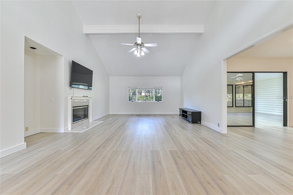 5355 Cobblestone Court Wesley Chapel, FL 33543 - Photo 18 of 59 wooden floor in an empty room with a window