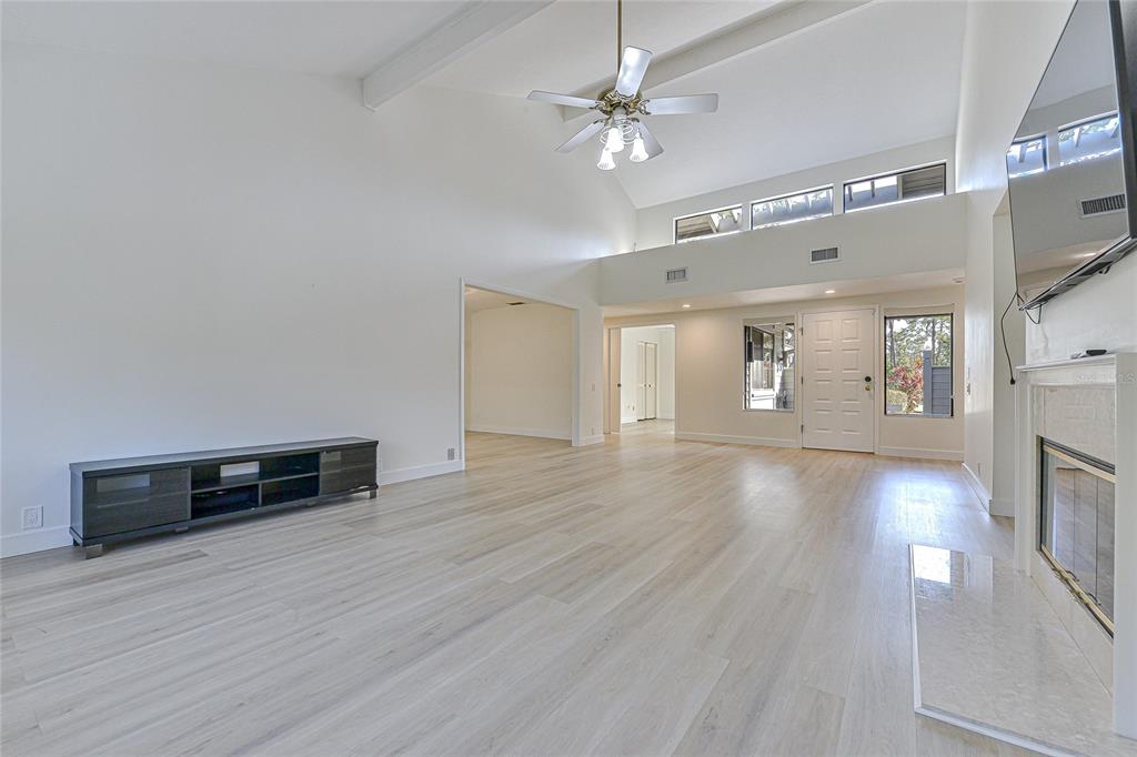 5355 Cobblestone Court Wesley Chapel, FL 33543 - Photo 20 of 54 a view of a livingroom with furniture wooden floor and a ceiling fan