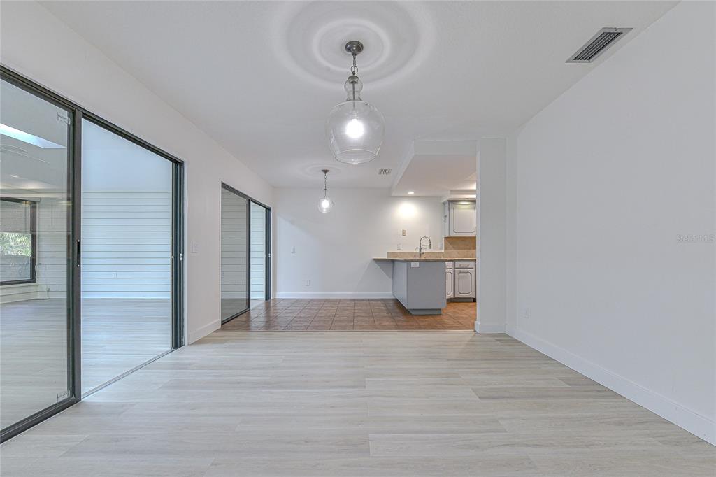 5355 Cobblestone Court Wesley Chapel, FL 33543 - Photo 21 of 54 a view of a kitchen with a sink and chandelier