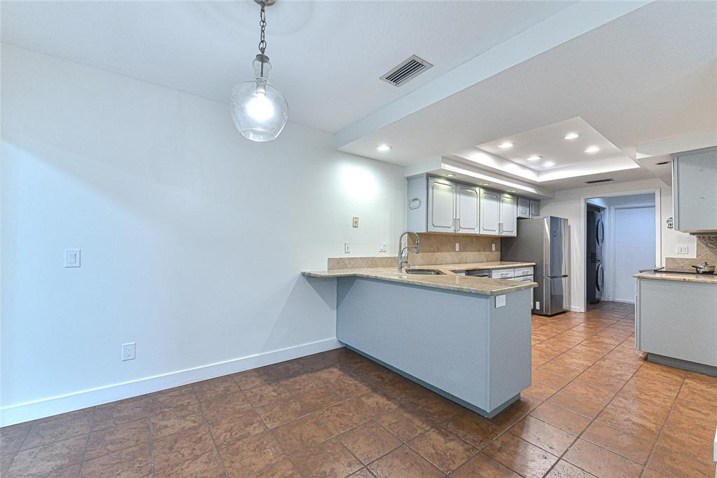 5355 Cobblestone Court Wesley Chapel, FL 33543 - Photo 24 of 54 a kitchen with granite countertop a sink and cabinets
