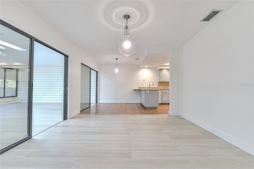 5355 Cobblestone Court Wesley Chapel, FL 33543 - Photo 24 of 59 an empty room with wooden floor and windows