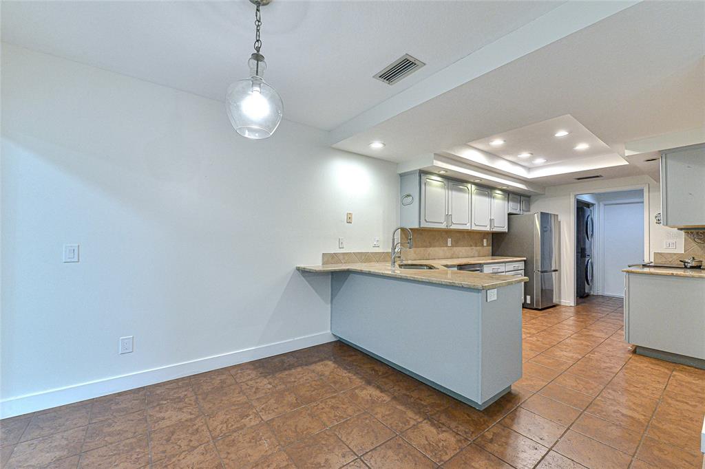 5355 Cobblestone Court Wesley Chapel, FL 33543 - Photo 25 of 54 a kitchen with stainless steel appliances granite countertop a sink and a stove