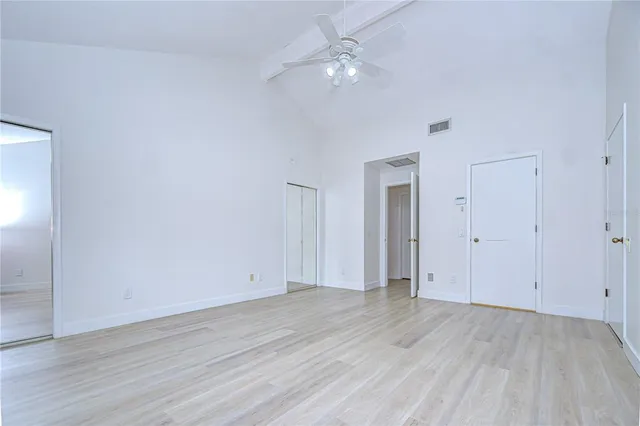 a spacious bathroom with a granite countertop sink a mirror and a bathtub