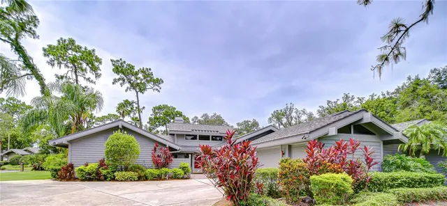 a front view of a house with a yard and potted plants