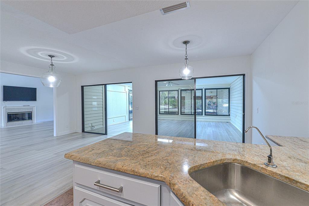 5355 Cobblestone Court Wesley Chapel, FL 33543 - Photo 31 of 54 a kitchen with a sink cabinets and chandelier