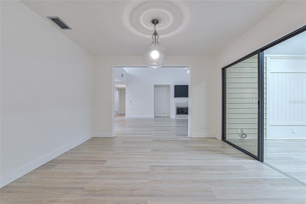 5355 Cobblestone Court Wesley Chapel, FL 33543 - Photo 32 of 54 a view of a room with wooden floor and entryway
