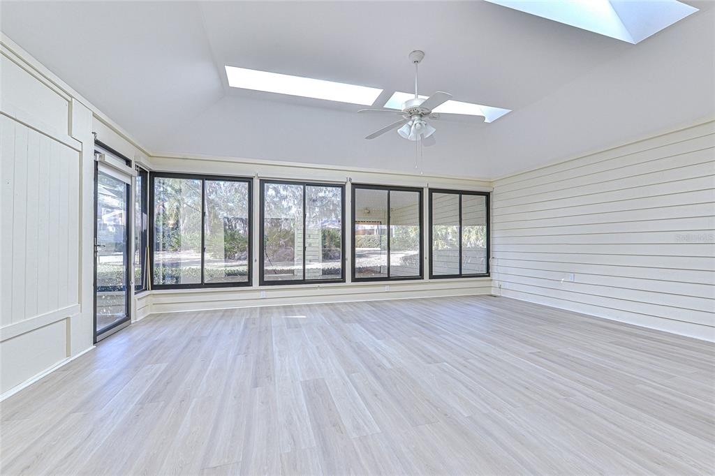 5355 Cobblestone Court Wesley Chapel, FL 33543 - Photo 36 of 59 wooden floor in an empty room with a window