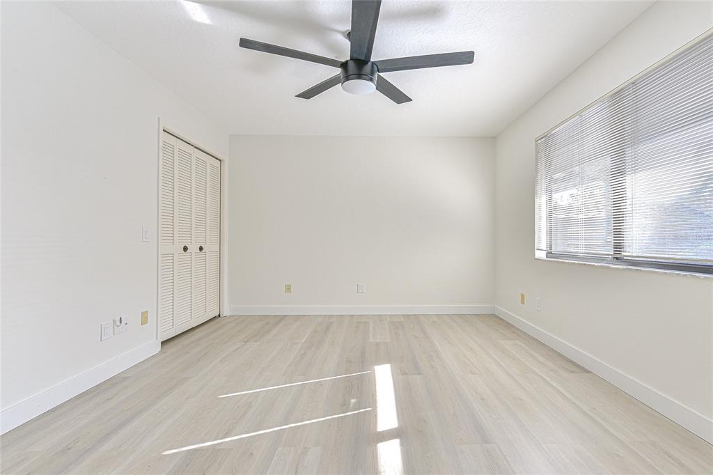 5355 Cobblestone Court Wesley Chapel, FL 33543 - Photo 38 of 54 an empty room with windows and fan