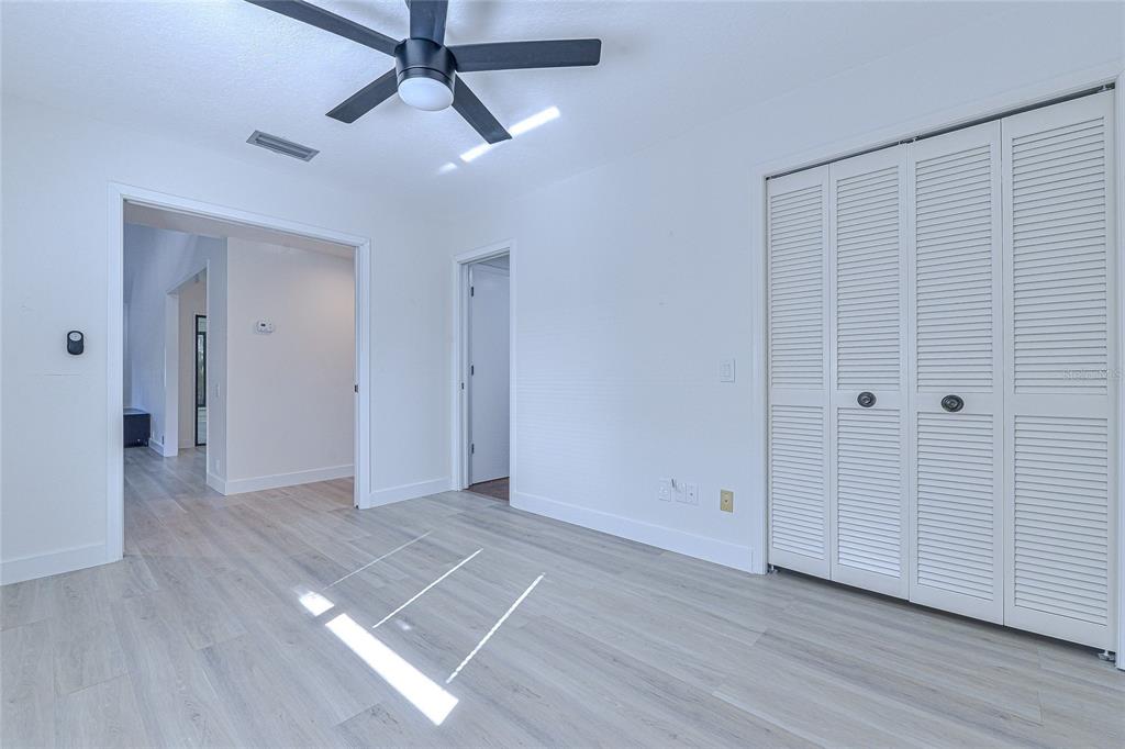 5355 Cobblestone Court Wesley Chapel, FL 33543 - Photo 40 of 54 a view of an empty room with wooden floor