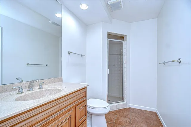 a large kitchen with granite countertop a sink and dishwasher a stove top oven with wooden floor