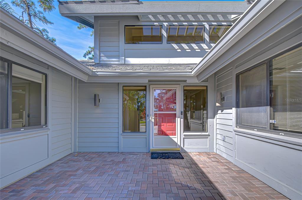 5355 Cobblestone Court Wesley Chapel, FL 33543 - Photo 4 of 54 a view of a porch with a door and wooden floors