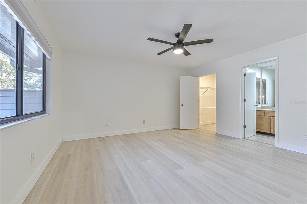 5355 Cobblestone Court Wesley Chapel, FL 33543 - Photo 46 of 59 a view of empty room with wooden floor and window