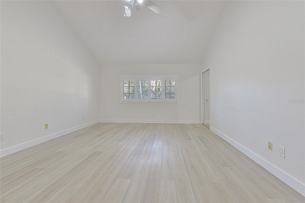 5355 Cobblestone Court Wesley Chapel, FL 33543 - Photo 48 of 54 wooden floor in an empty room with a window