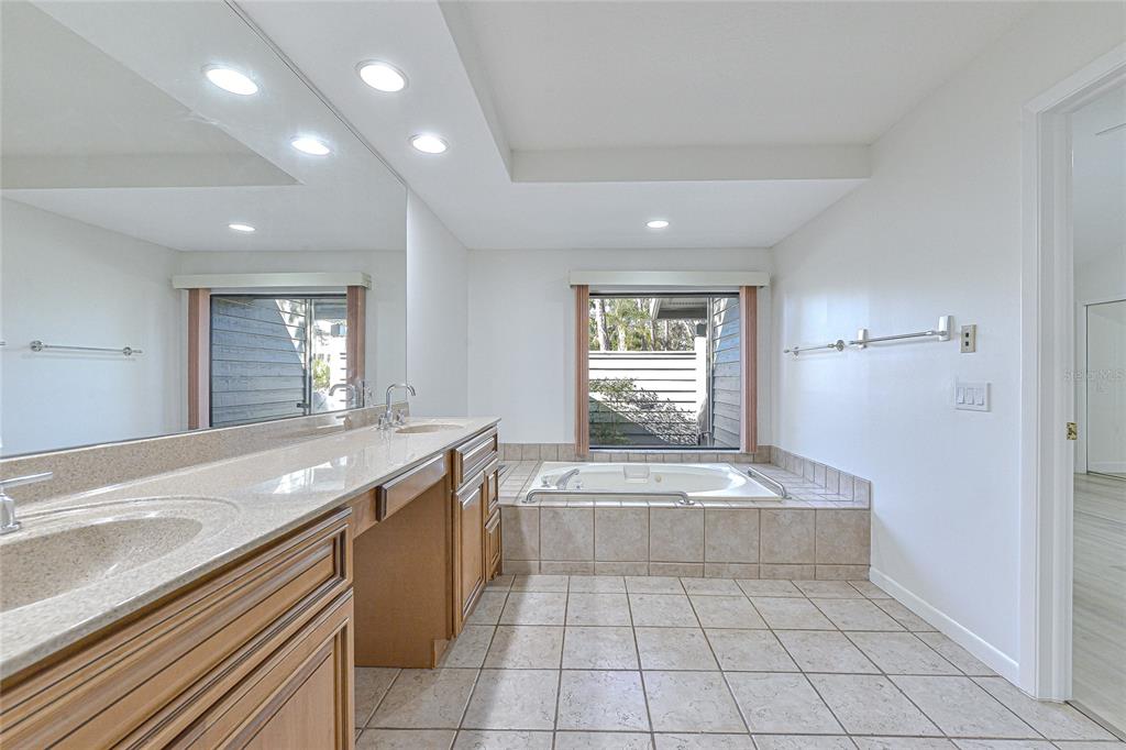 5355 Cobblestone Court Wesley Chapel, FL 33543 - Photo 52 of 54 a large kitchen with granite countertop a sink and a stove top oven