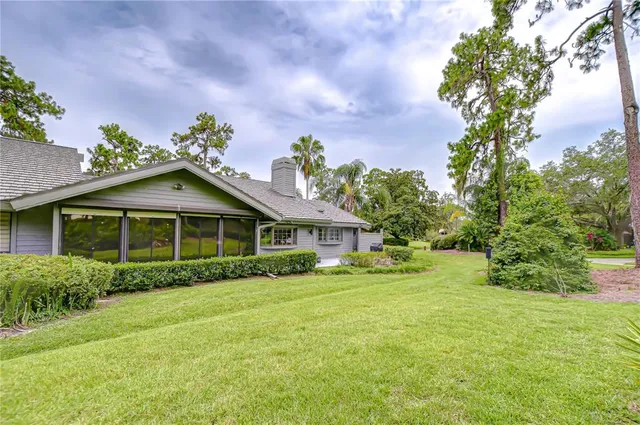 a backyard of a house with lots of green space and plants