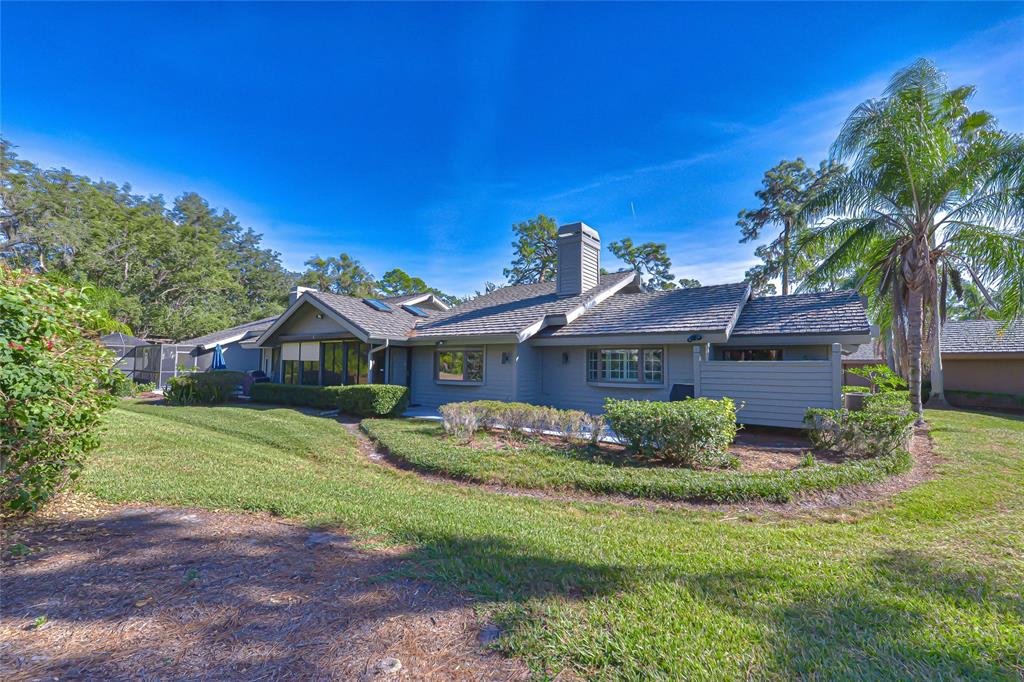 5355 Cobblestone Court Wesley Chapel, FL 33543 - Photo 10 of 54 a front view of a house with a garden