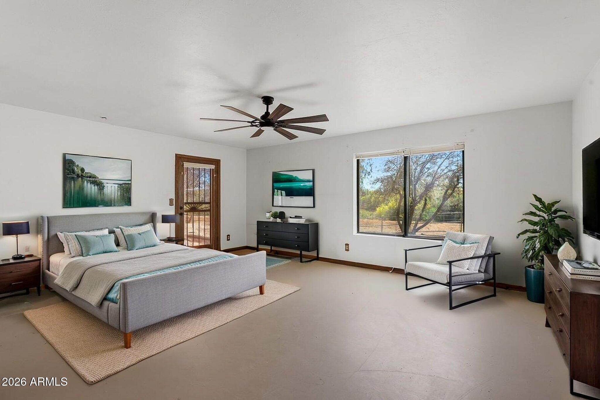1302 East Maddock Road Phoenix, AZ 85086 - Photo 17 of 40 a bedroom with a bed a couch and a window