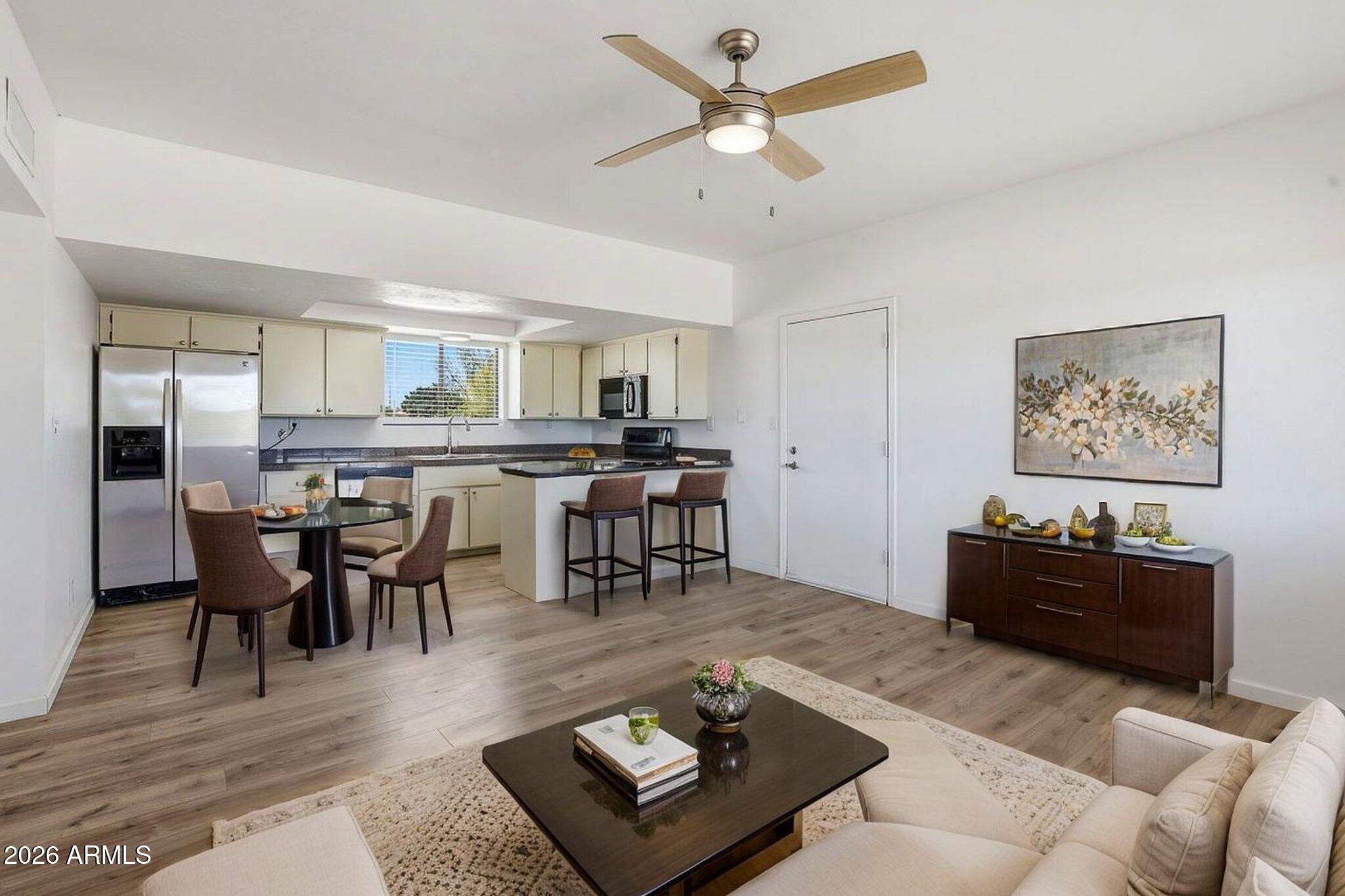 1302 East Maddock Road Phoenix, AZ 85086 - Photo 35 of 40 a living room with furniture a dining table and kitchen view