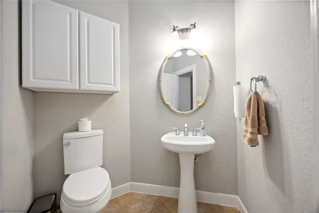 a bathroom with a sink toilet and a mirror